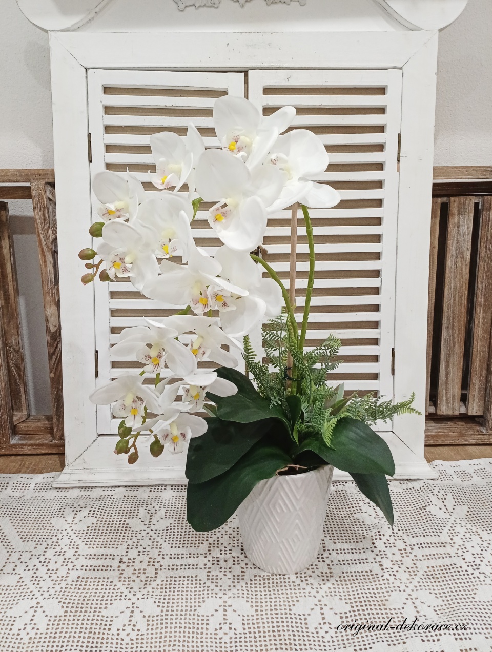 Bílá orchidej v bílém keramickém obalu